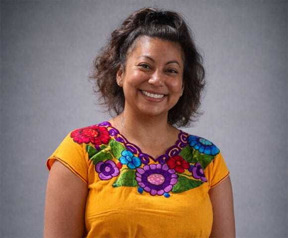 Amores Daycare founder with children in the classroom
